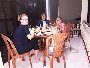 a group of people sitting at a table at Sunny Side Villa in Tangalle