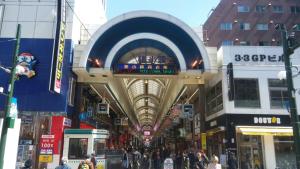 a shopping mall with people walking in the street at Hotel Tetora Spirit Sapporo in Sapporo