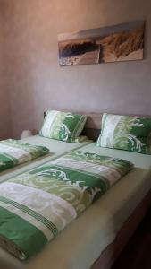 two beds sitting next to each other in a room at Ferienapartment Schlosser in Diez