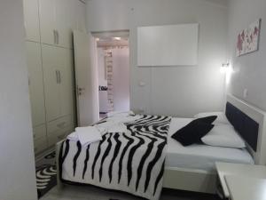 a room with a bed with a zebra print blanket at Vip Apartment by "Murati" in Ksamil +27 photos