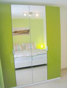 a bedroom with a glass partition with a bed in it at Krabbentaucher 1**** in Neßmersiel