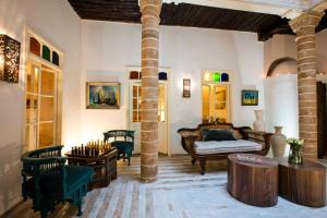 a living room with a couch and a table at Riad Emotion in Essaouira