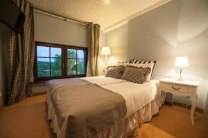 a bedroom with a large bed and a window at Dom Wiejska 39 a in Ruciane-Nida