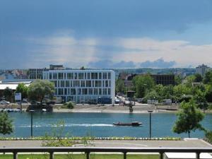 a large river with a building and a boat in it at Ferienwohnung Lac Konstanz in Konstanz