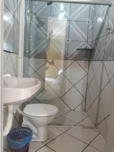 a bathroom with a toilet and a sink at Novo Hotel in Carolina