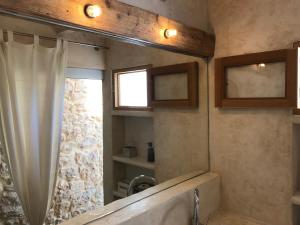 a bathroom with a tub and a shower with a window at Encanto y Hadas in Sant Francesc Xavier +49 photos