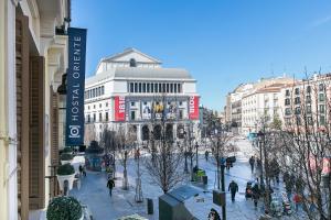 a city street with buildings and people walking around at Hostal Oriente in Madrid