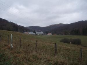 a fence in a field with houses in the background at Albergue Irugoienea in Espinal-Auzperri