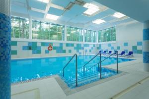 a large swimming pool with blue and white tiles at Best Western Hotel Jurata in Jurata