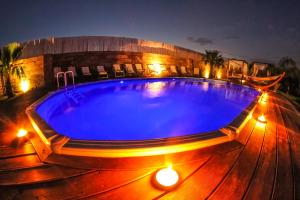 una piscina con luci su una terrazza in legno di notte di Villa con Piscina by Corallo Blu Salento a Taviano