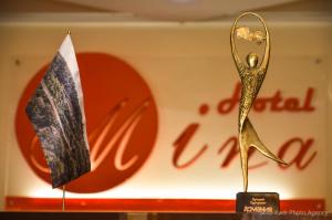 a flag and a gold statue of a woman at Mina Hotel in Goris