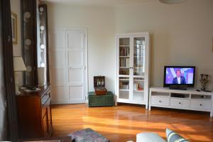 a living room with a flat screen tv on a table at Jacques MELCHIOR meublé de tourisme 3 étoiles Intra Muros in Saint Malo