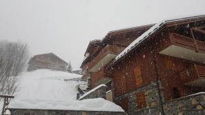 a pile of snow on the side of a building at Arpege Des Neiges in Sainte-Foy-Tarentaise