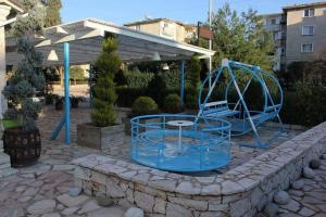 a playground with a blue slide in a yard at Vip Apartment by "Murati" in Ksamil