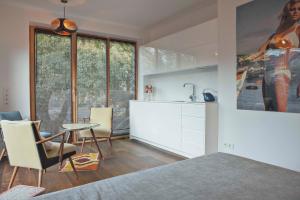 a kitchen with a table and chairs and a sink at Baltic Beach Retreat in Nida