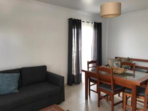 a living room with a couch and a table at Apartamento T&T Ocean - Vista Mar in Portimão