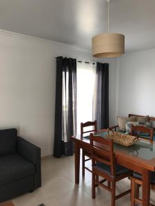 a living room with a table and a couch at Apartamento T&T Ocean - Vista Mar in Portimão