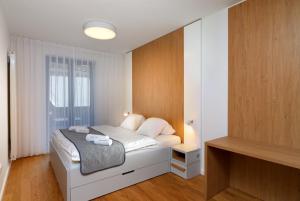 Postel nebo postele na pokoji v ubytování Apartments Residence Grand