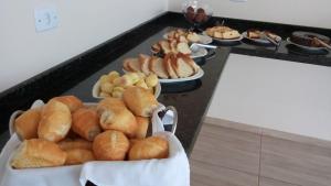 a buffet with a bunch of bread and other pastries at Golden Hotel in Vilhena +14 photos