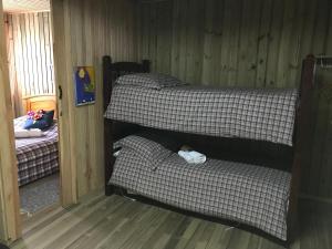 2 Etagenbetten in einem Zimmer mit Holzböden in der Unterkunft Estalagem Carucacas in Bom Jardim da Serra