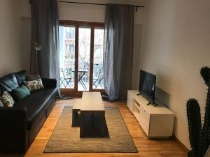 a living room with a couch and a table and a tv at AZ El Balcón de Conde de Aranda II in Zaragoza