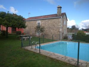 a swimming pool in front of a building at Casa Socorro in A Estrada