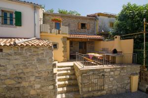 a house with a stone wall and a guitar at Residence Hidden Heaven in Buzet