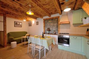 a kitchen with a table and a couch in a room at Residence Hidden Heaven in Buzet