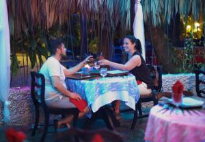 a man and woman sitting at a table drinking wine at Abezza Resort And Spa in Maskall