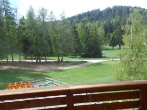a view of a park from a wooden fence at Il Falchetto in Sarnonico