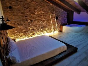 a bedroom with a bed with lights on the wall at El Racó de Valderrobres in Valderrobres