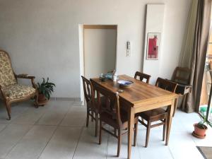 a dining room with a wooden table and chairs at Domaine de la Coteire in Cugy +14 photos