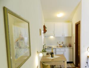a small kitchen with a table and a sink at Mare in Baška Voda