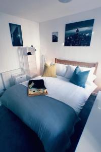 a large bed in a room with a blue blanket at Castle Terrace (B3 R3) in Dudley