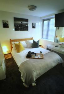 a bedroom with a large bed with a tray on it at Castle Terrace (B3 R3) in Dudley