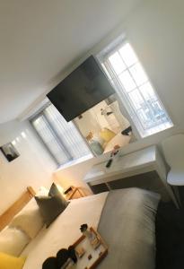 a bedroom with a bed and a large window at Castle Terrace (B3 R3) in Dudley