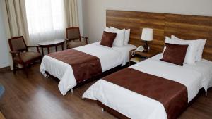 Postel nebo postele na pokoji v ubytování Hotel Nutibara