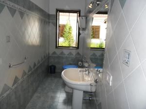 a bathroom with a sink and a toilet at Pousada Romantica in Tropea