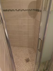 a shower with a glass door in a bathroom at Hotel Rivoli in Paris