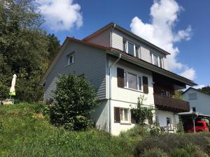 a white house with a brown roof at Alpenpanorama am Hochrhein in Gailingen
