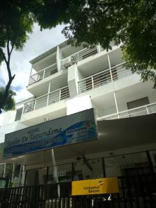 a white building with a sign in front of it at Hotel Jardin De Tequendama in Cali