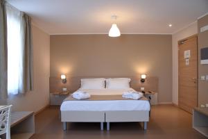 Posteľ alebo postele v izbe v ubytovaní Nuovo Albergo Operai