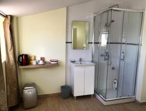 a bathroom with a shower and a sink at Caravela in Perafita +52 photos