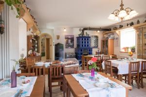 a dining room with wooden tables and chairs at B&B La Gerla Blu in Tolmezzo