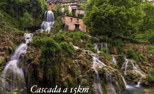 a group of waterfalls on the side of a mountain at Hostal Sanpatiel in Polientes