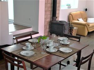 a dining room table with a fireplace in a living room at Casas da Baronia in Vila Nova da Baronia