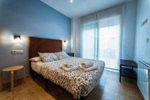 a bedroom with two dolls laying on a bed at Apartamentos Amanecer JC1 in Murcia