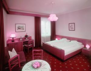 a bedroom with a bed and a desk and a table at Plonerhof in Lagundo +28 photos
