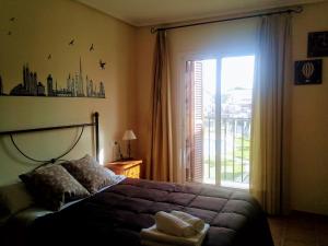 a bedroom with a bed and a large window at Al-Andalus Thalassa Home Star in Vera +48 photos