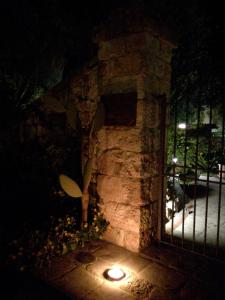 a stone fireplace with a light in the dark at Masseria Asciano in Ostuni